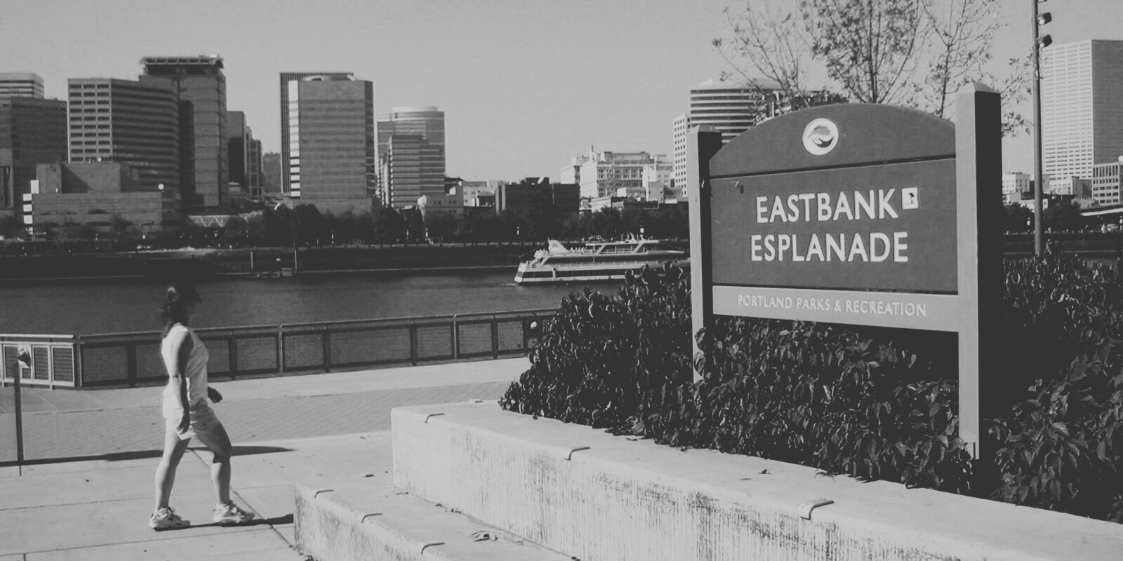 Pedestrian enjoying Eastbank Esplanade in Portland B&W