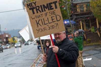 David Sale holds a sign at a demonstration reading "Hey Trimet What if she killed your kid?"