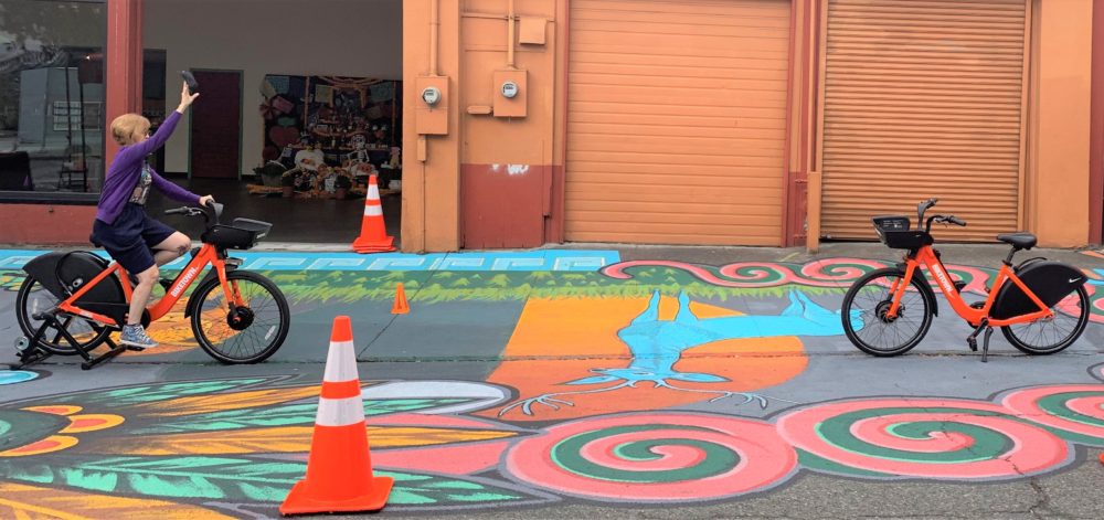 Teatro Milagro Artistic Director Dañel Malán plays BIKETOWN bean bag toss