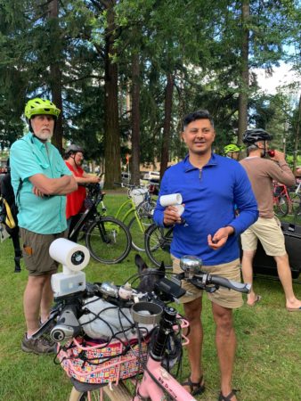 Professor Vivek Shandas holds a handlebar heat monitor while Milwaukie Mayor Mark Gamba looks on