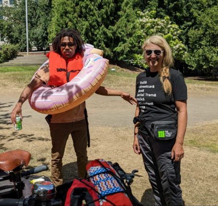 OUtdoor fun - Andre in a Doughnut Float, Madi looking sleek in Black logo tee and pants