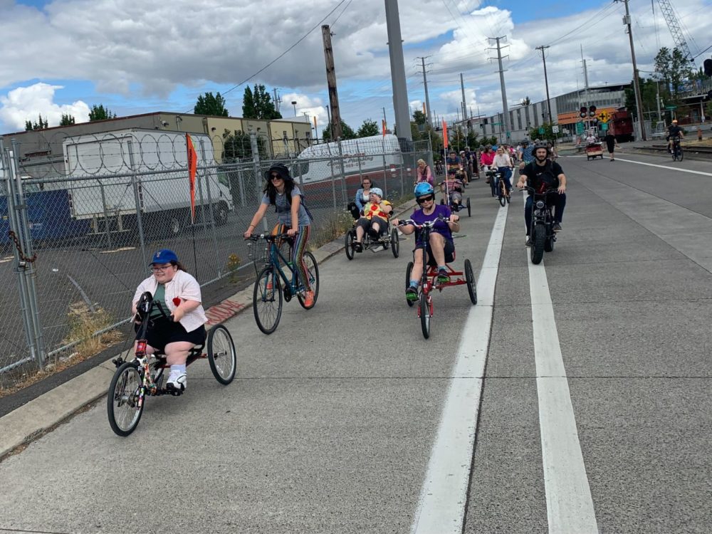 Group of people riding adaptive and traditional cycles.