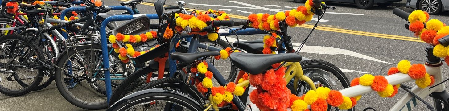 Parked bikes decorated with marigold garlands